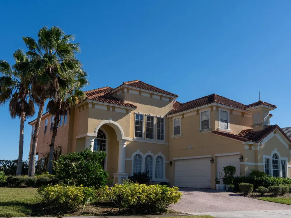 Two-story homes with palm trees in Wyndham Lakes Estates